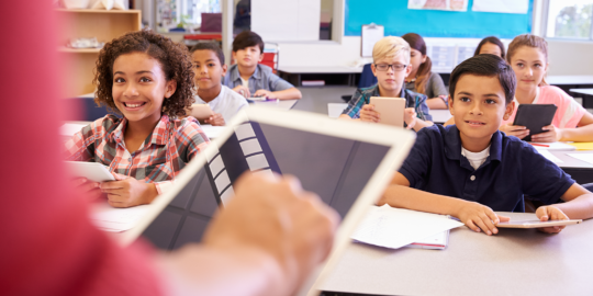 Teaching using an iPad in front of class.