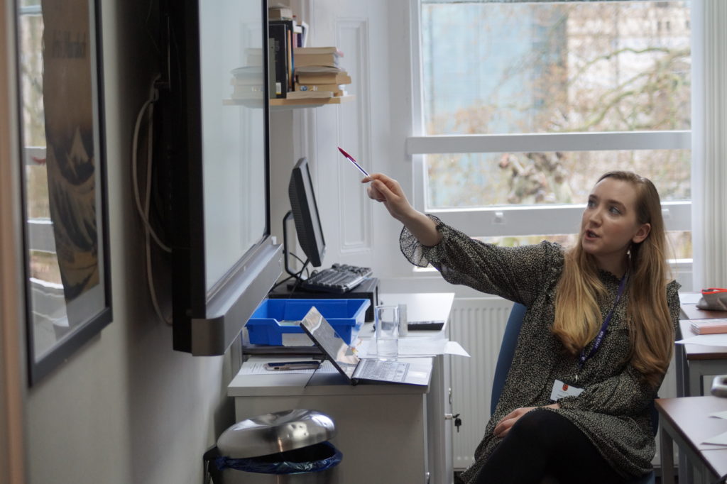 Teaching pointing at large screen at front of class