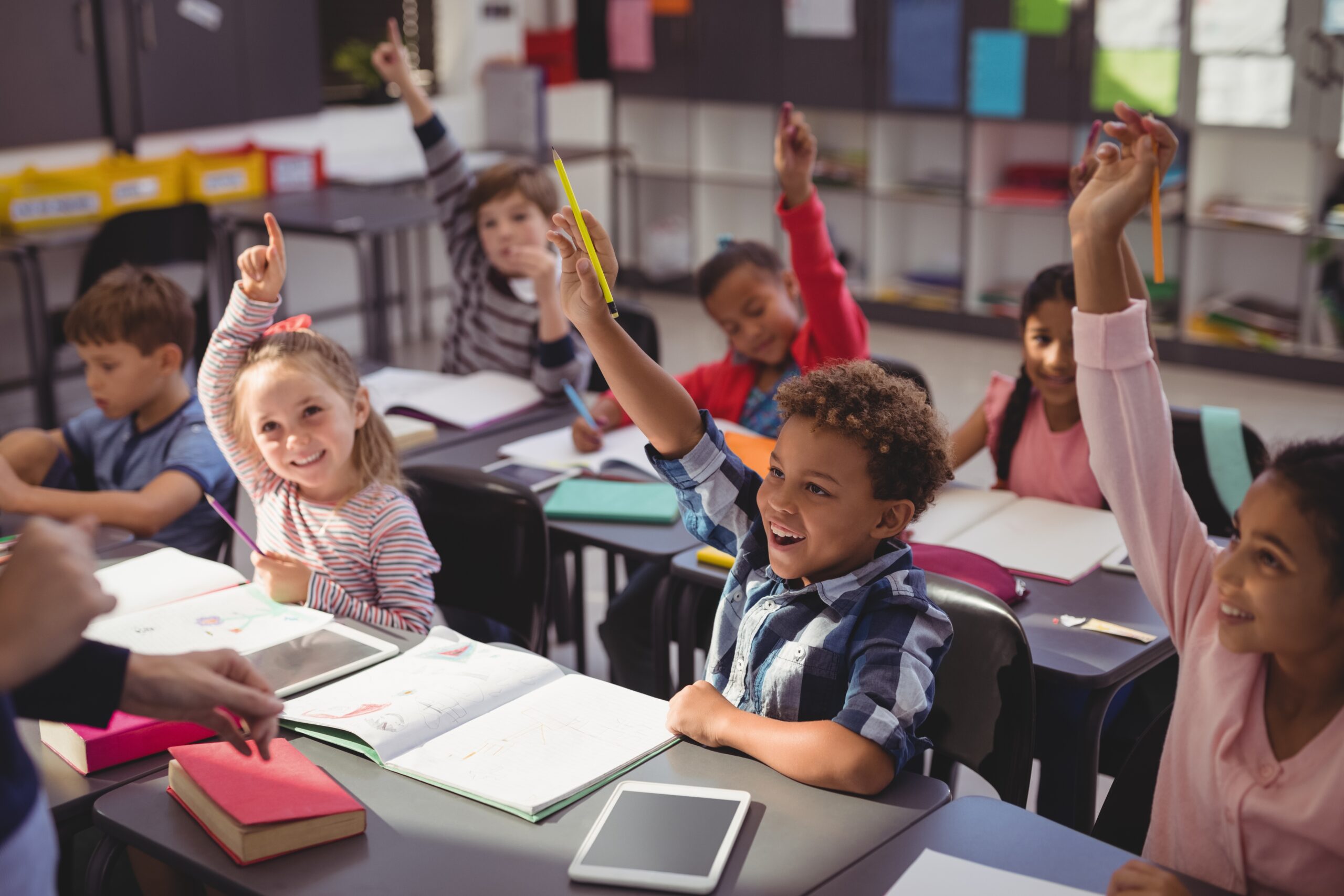 how to build a positive school culture: 10 do’s and don'ts from the pros 1 Schoolkids raising their hands in classroom