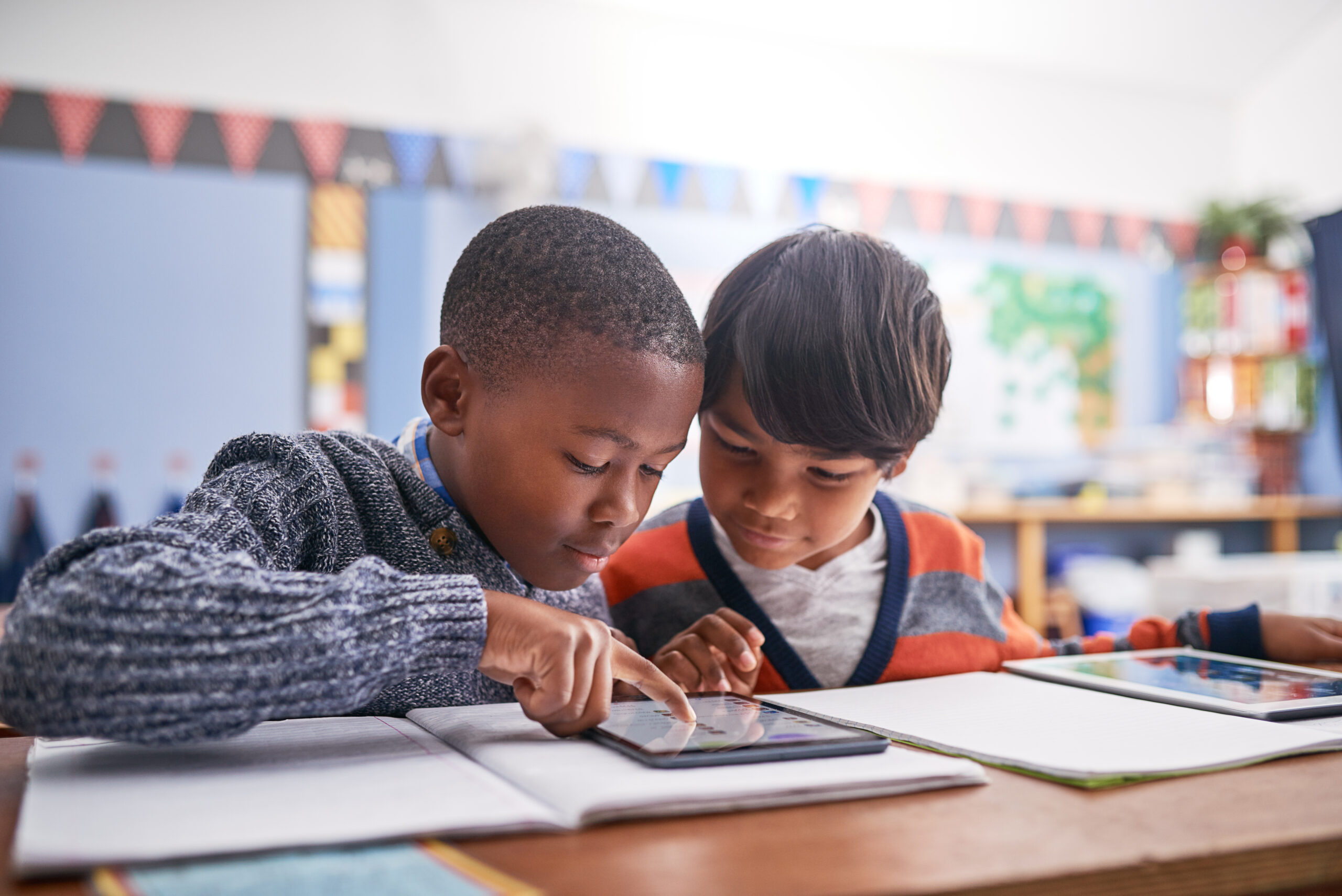 5 steps to ensure your classroom technology refresh delivers 1 Students in classroom doing research for work, test or exam. Technology, education and boy children friends working on project or assignment together with mobile on campus