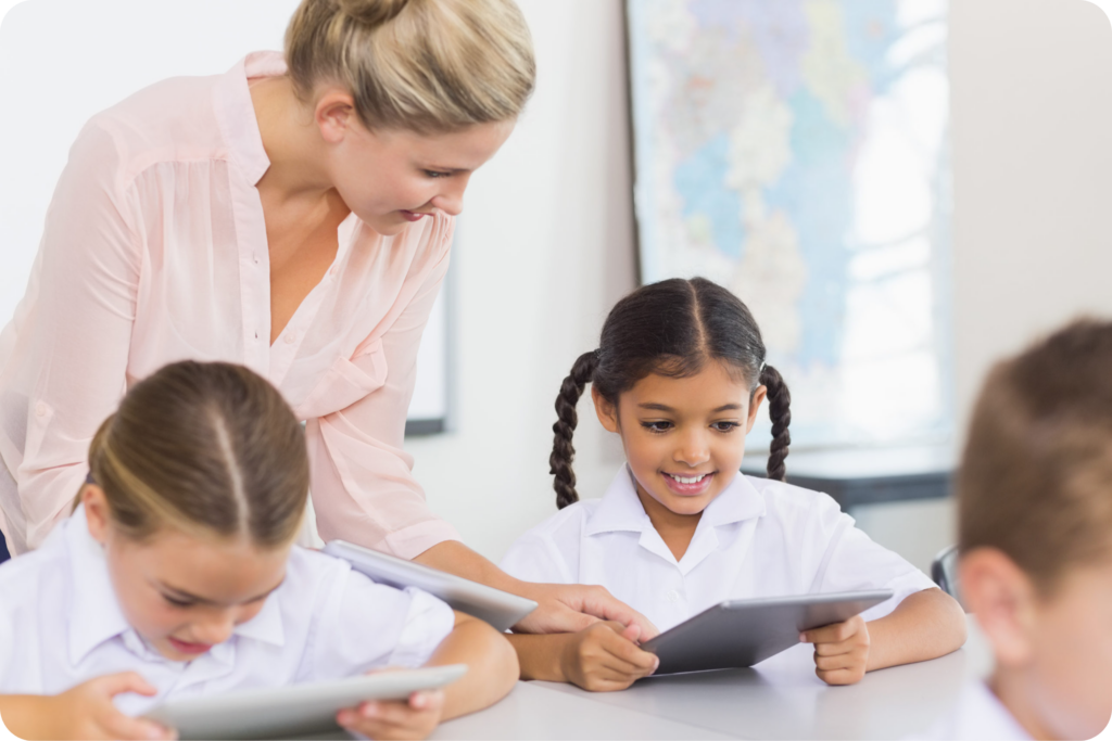 Upgrade Smarter: Is Your School Ready for IFP Alternatives? 3 Teacher providing instruction using a digital tablet.