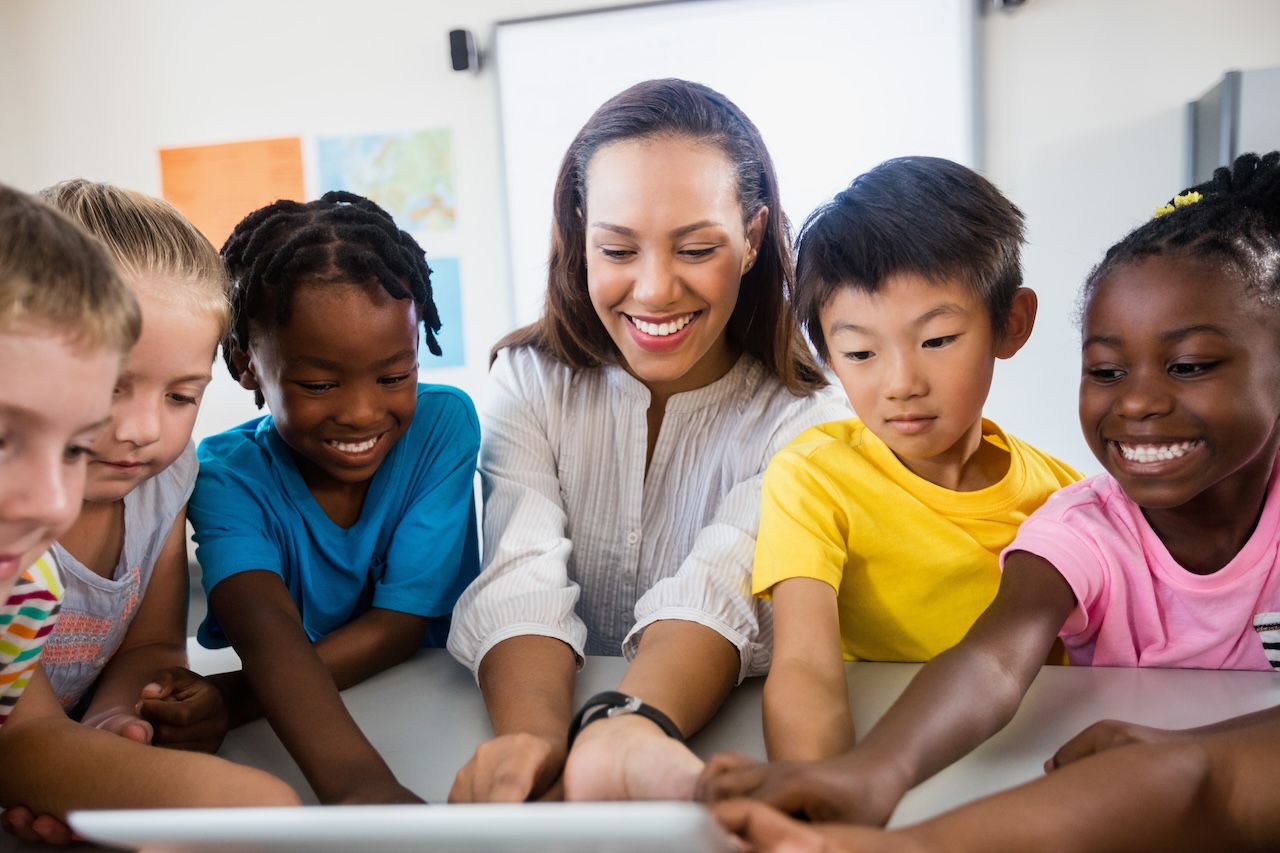 kickstart the school year: 8 innovative tech tips for teachers 1 Portrait of teacher with pupil using tablet pc