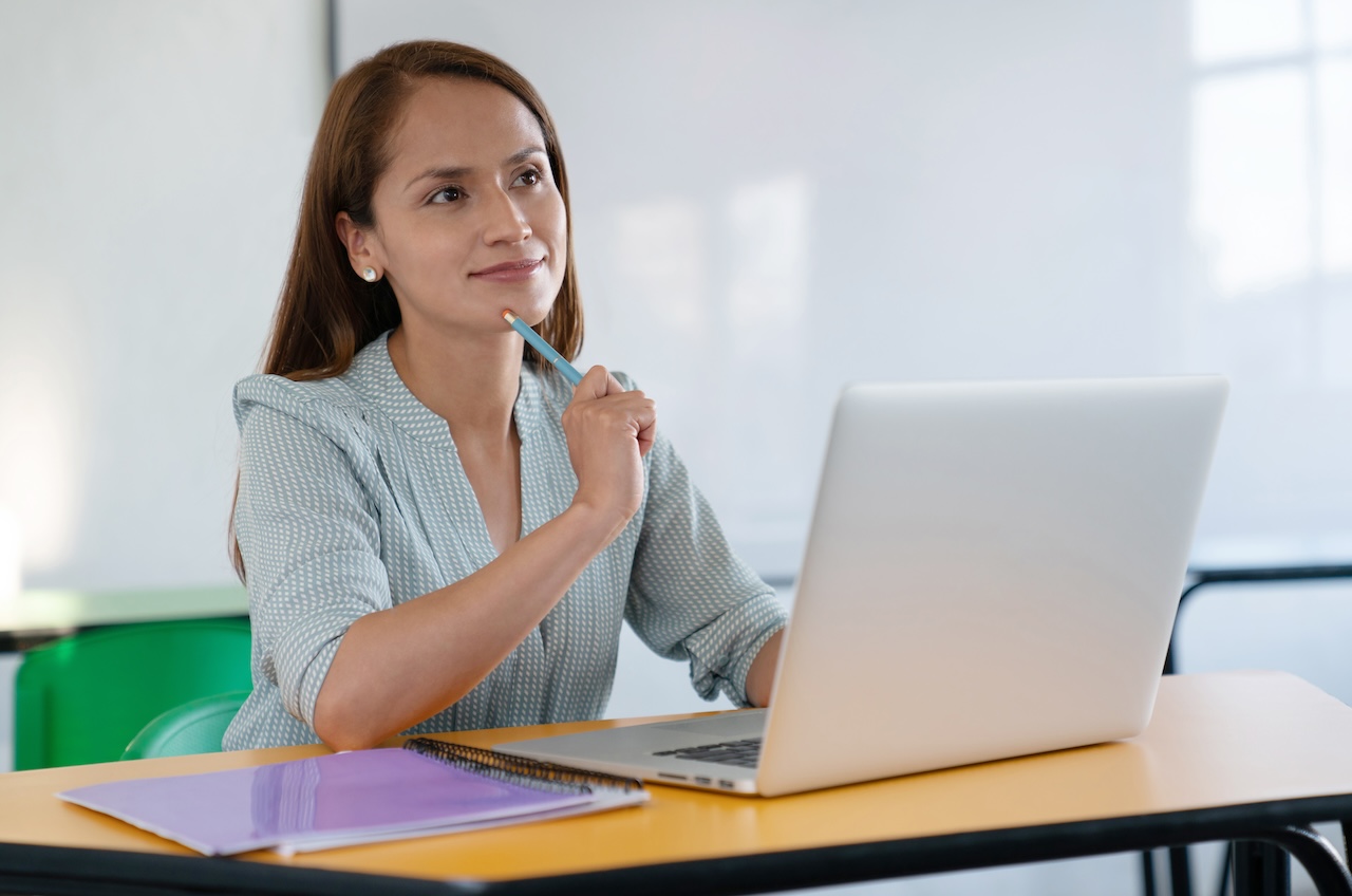 top teacher time management tools and tips for success 1 Female teacher thinking in front of the computer in the classroom