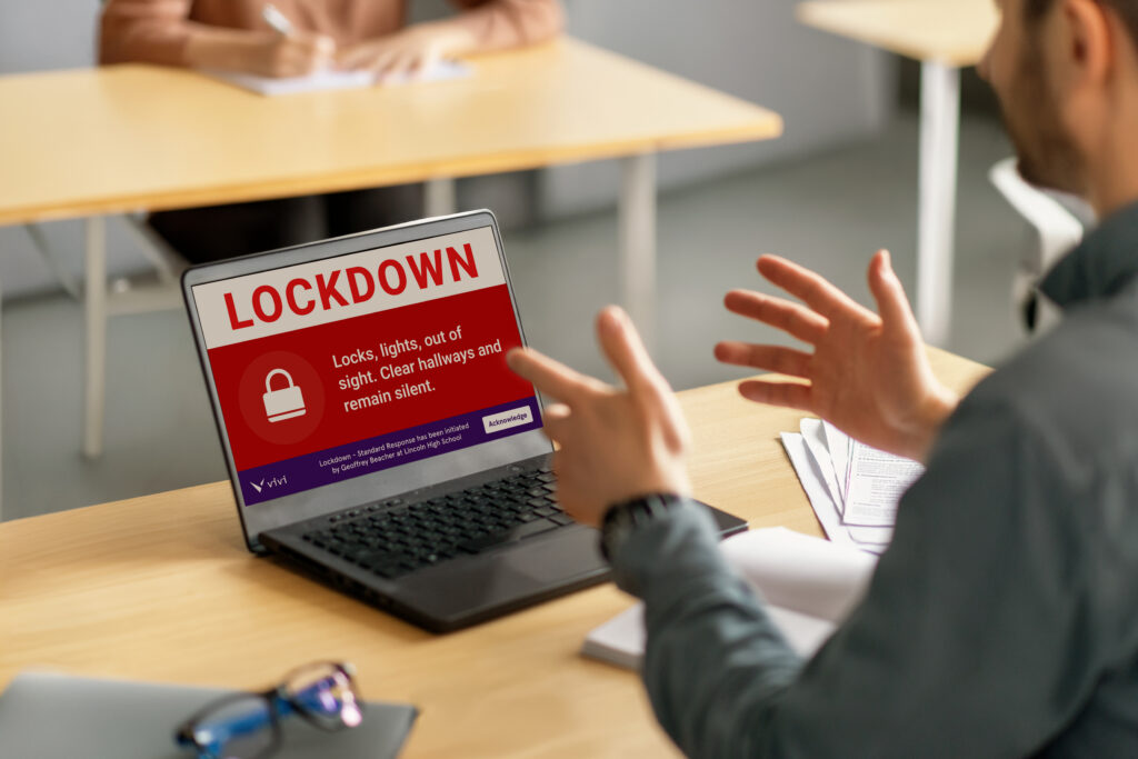 Visual lockdown alert displayed on a classroom screen in a UK school